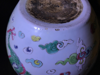 A Chinese blue and white fish bowl and a famille rose 'dragon' jardini&egrave;re, 19th C. and Yongzheng
