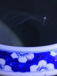 A Chinese blue and white fish bowl and a famille rose 'dragon' jardini&egrave;re, 19th C. and Yongzheng