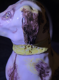 A manganese and yellow Brussels faience model of a dog, 18th C.