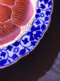 Four Chinese blue, white and iron red 'lotus' plates, Qianlong/Jiaqing