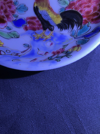 A pair of Chinese famille rose 'roosters' cups and saucers, Yongzheng/Qianlong