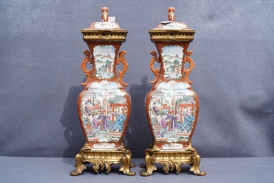 A pair of large Chinese ormolu-mounted famille rose 'mandarin' vases and covers, Qianlong