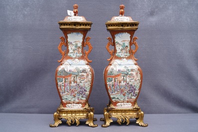 A pair of large Chinese ormolu-mounted famille rose 'mandarin' vases and covers, Qianlong