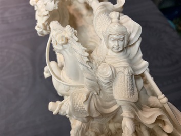 A Chinese carved ivory group with warriors on horseback, 2nd quarter 20th C.