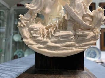 A Chinese carved ivory group with warriors on horseback, 2nd quarter 20th C.