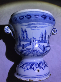 A pair of small Dutch Delft blue and white 'campana' vases on stands, 18th C.
