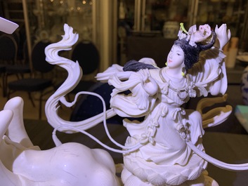 A large Chinese ivory group of an elephant with two ladies, 1st half 20th C.