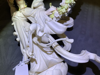 A large Chinese ivory group of an elephant with two ladies, 1st half 20th C.