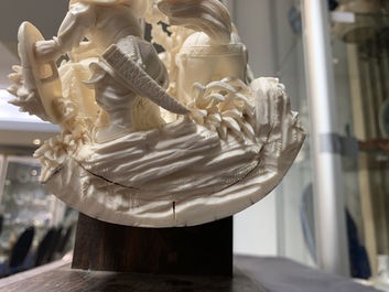 A Chinese carved ivory group with warriors on horseback, 2nd quarter 20th C.