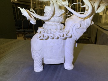 A large Chinese ivory group of an elephant with two ladies, 1st half 20th C.