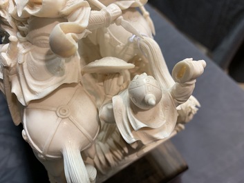 A Chinese carved ivory group with warriors on horseback, 2nd quarter 20th C.