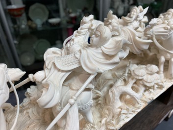 A Chinese carved ivory group with warriors on horseback, 2nd quarter 20th C.