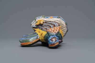 A polychrome Dutch Delft group of a hen with chickens, 18th C.
