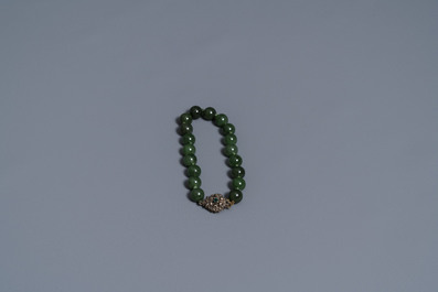 Two Chinese necklaces and a bracelet with spinach green jade beads, 20th C.