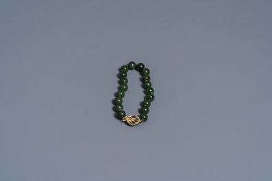 Two Chinese necklaces and a bracelet with spinach green jade beads, 20th C.
