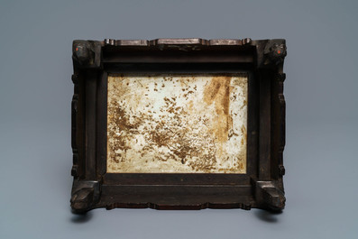 A Chinese carved wooden stand with famille rose plaque, 19th C.