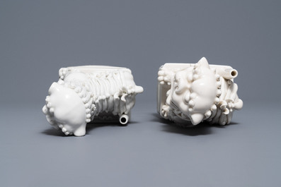 A pair of large Chinese Dehua blanc de Chine buddhist lion joss stick holders, Kangxi