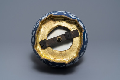 A Chinese blue-ground slip-decorated bottle vase with ormolu mounts, 19th C.