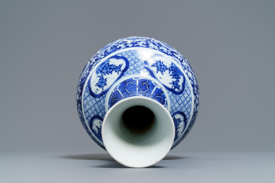 A Chinese blue and white bottle vase with dancers on a floral ground, 19th C.