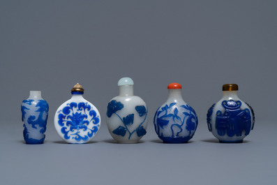 Nine various Chinese blue overlay glass snuff bottles, 19/20th C.