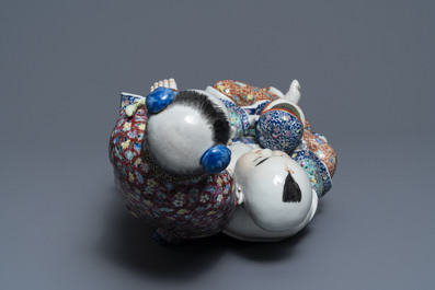 A Chinese famille rose group of two children, impressed marks, Republic, 20th C.