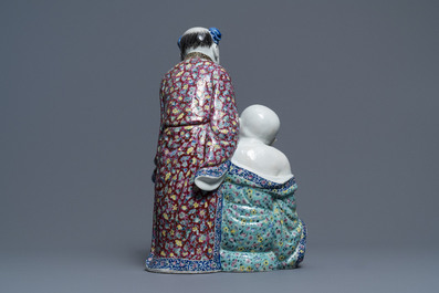 A Chinese famille rose group of two children, impressed marks, Republic, 20th C.
