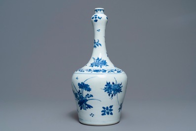 A Chinese blue and white bottle vase with floral design, Transitional period