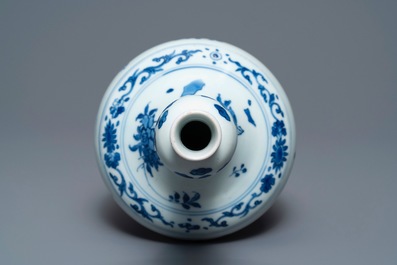 A Chinese blue and white bottle vase with floral design, Transitional period