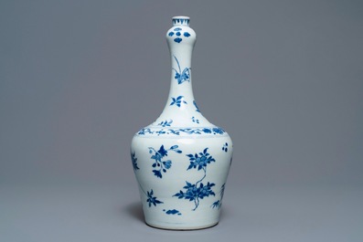 A Chinese blue and white bottle vase with floral design, Transitional period