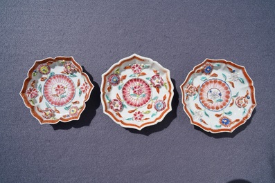 A Chinese famille rose relief-decorated teapot, milk jug and tea caddy on stands, Yongzheng