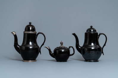 Four silver-mounted Namur black-glazed pottery coffeepots and a teapot, 18th C.
