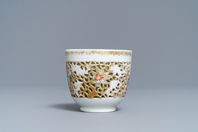 A reticulated Chinese famille rose cup and saucer, Qianlong