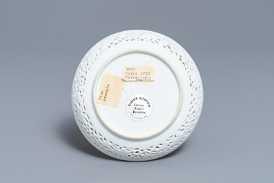 A reticulated Chinese famille rose cup and saucer, Qianlong