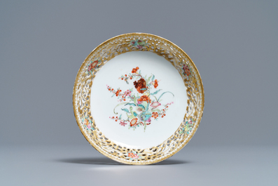 A reticulated Chinese famille rose cup and saucer, Qianlong