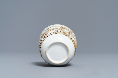 A reticulated Chinese famille rose cup and saucer, Qianlong