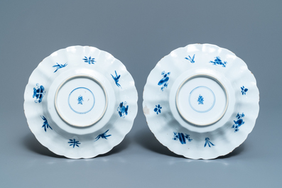 Two Chinese blue and white gadrooned 'crabs and carps' dishes and a pair of plates, Kangxi
