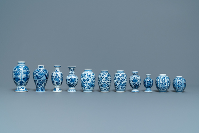 Eleven small Chinese blue and white vases with floral design, Kangxi