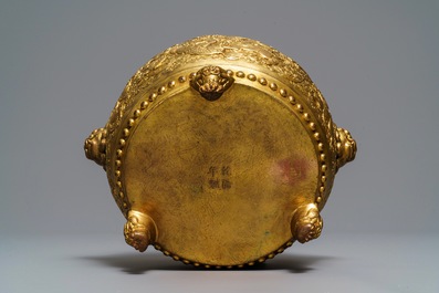 A Chinese gilt bronze tripod censer with buddhist lions, Qianlong mark, 19/20th C.