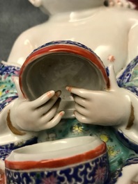 A Chinese famille rose group of two children, impressed marks, Republic, 20th C.