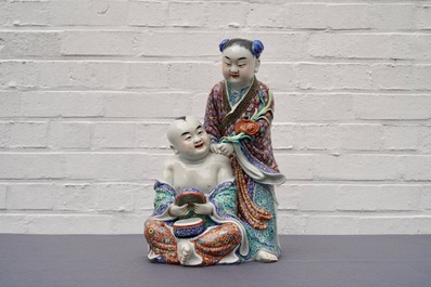 A Chinese famille rose group of two children, impressed marks, Republic, 20th C.
