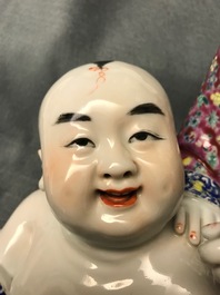 A Chinese famille rose group of two children, impressed marks, Republic, 20th C.