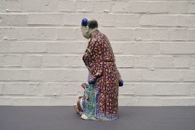 A Chinese famille rose group of two children, impressed marks, Republic, 20th C.