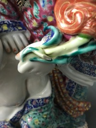 A Chinese famille rose group of two children, impressed marks, Republic, 20th C.