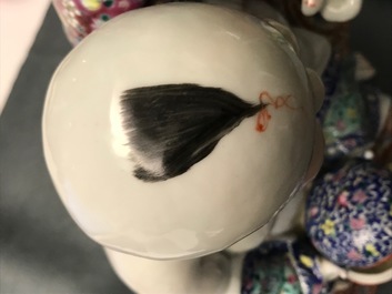 A Chinese famille rose group of two children, impressed marks, Republic, 20th C.