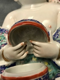 A Chinese famille rose group of two children, impressed marks, Republic, 20th C.