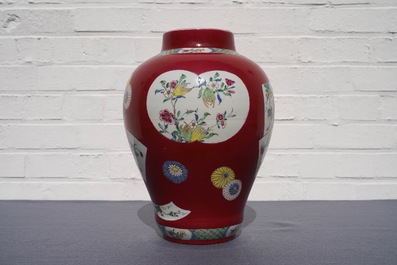 A fine Chinese famille rose ruby ground baluster vase with floral panels, Yongzheng