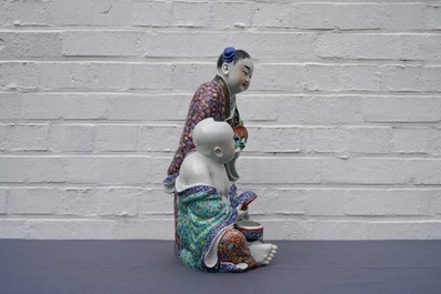 A Chinese famille rose group of two children, impressed marks, Republic, 20th C.