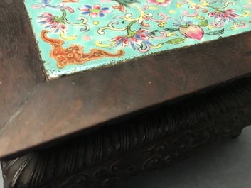A Chinese carved wooden stand with famille rose plaque, 19th C.