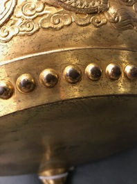 A Chinese gilt bronze tripod censer with buddhist lions, Qianlong mark, 19/20th C.