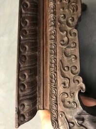 A Chinese carved wooden stand with famille rose plaque, 19th C.